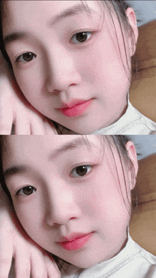 a close up of a young girl 's face with a white shirt on