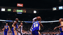 a basketball game is being played in a stadium with budweiser advertisements