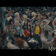 a group of people are dancing and one of them has a jump shirt on