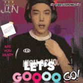a man wearing headphones and a black shirt that says let 's goooo go
