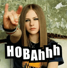 a woman sitting on a couch with a sign that says hobahnh on it