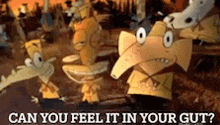 a group of cartoon characters standing next to each other with the words `` can you feel it in your gut '' written on the bottom .