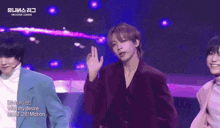 a group of young men are performing on a stage in front of a sign that says ' universe league '