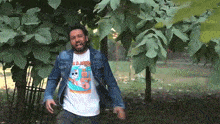 a man in a denim jacket and a t-shirt that says ' mr. jerry ' on it