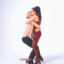 a man is carrying a woman in his arms with the words come here baby written below them