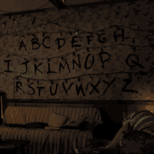 the letters abcdefgh ijklmnopq rstuvwxyz are painted on the wall