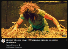 a screenshot of a video of a woman crawling through a pile of cigarettes