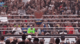 a man in a wrestling ring with a sign that says shawe