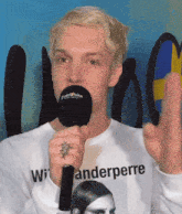 a man holding a microphone that says eurovision