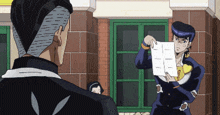 a man is holding a piece of paper that says i on it