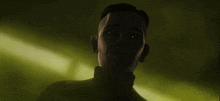 a close up of a man 's face in the dark with glowing eyes