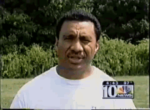 a man wearing a white shirt with the number 10 news on it