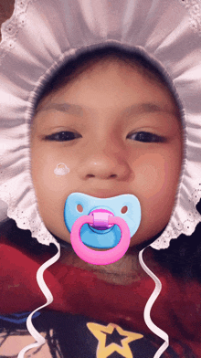 a baby with a pacifier in his mouth wearing a diaper