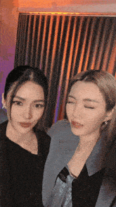 two women are posing for a picture and one has her eyes closed