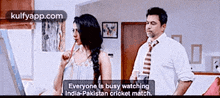 a man and a woman are standing next to each other in a room .