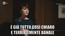 a tv screen shows a woman and the words " e gia tutto così chiaro e terribilmente banale "