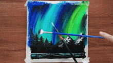 a painting of the aurora borealis is being painted with a brush