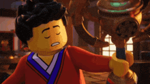 a lego character is holding a trophy with a x on it