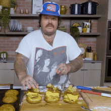 a man wearing a t-shirt that says b.e.m. is preparing food