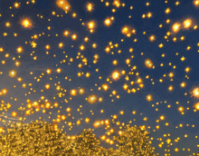a bunch of lights are flying in the air