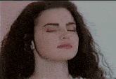 a close up of a woman 's face with eyes closed