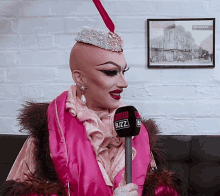 a woman is holding a microphone that says buzz