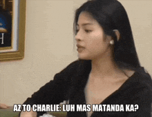 a woman sitting at a table with the words az to charlie luh mas matanda ka written below her