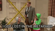 a man in a suit stands next to a girl in a green hoodie and says " i got lost in the metaphor