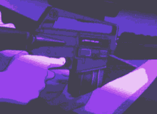 a pixel art of a person holding a gun in a purple light