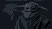 a group of stormtroopers are standing next to each other in a dark room with a statue of yoda in the background .