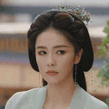 a close up of a woman 's face with a crown on her head
