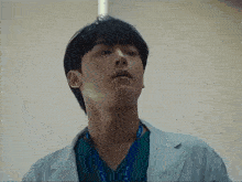 a man in a lab coat has a lanyard around his neck that says ' surgical ' on it