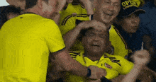 a man in a yellow shirt with the word open on the front