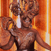 a woman is wearing a very elaborate costume with a large hat