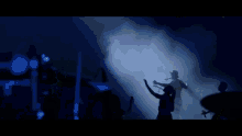 a silhouette of a person with their hand up in the air