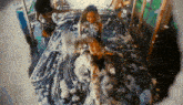 a woman laying on a car covered in foam
