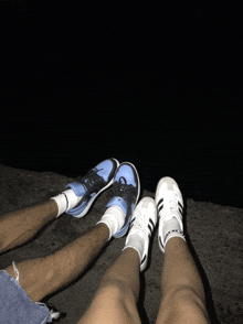 a man and a woman are sitting next to each other wearing blue and white shoes