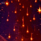 a woman 's face is surrounded by glowing stars in a dark room