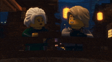 a couple of lego figures standing next to each other on a balcony