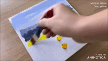 a person is painting a picture with medium yellow and deep yellow paints