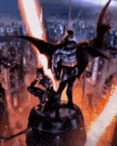 a statue of batman and catwoman standing next to each other in front of a city .