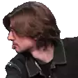 a man with long brown hair is wearing a black jacket and black shirt