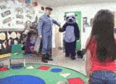 a girl standing in front of a man in a bear costume