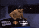 a shirtless man is dancing in a room in front of a machine .