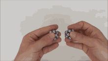 a person is holding a bunch of metal balls in their hand
