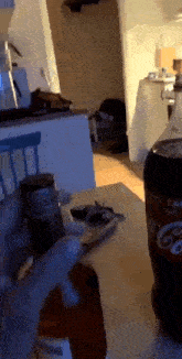 a bottle of coke sits on a wooden table