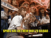 a man playing a piano in front of a crowd with the words spurs are on their way to bilbao
