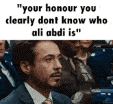 a man in a suit and tie with a caption that says " your honour you clearly dont know who ali abdi is "