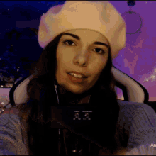 a woman wearing a white beret and headphones
