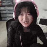 a girl wearing pink headphones with cat ears